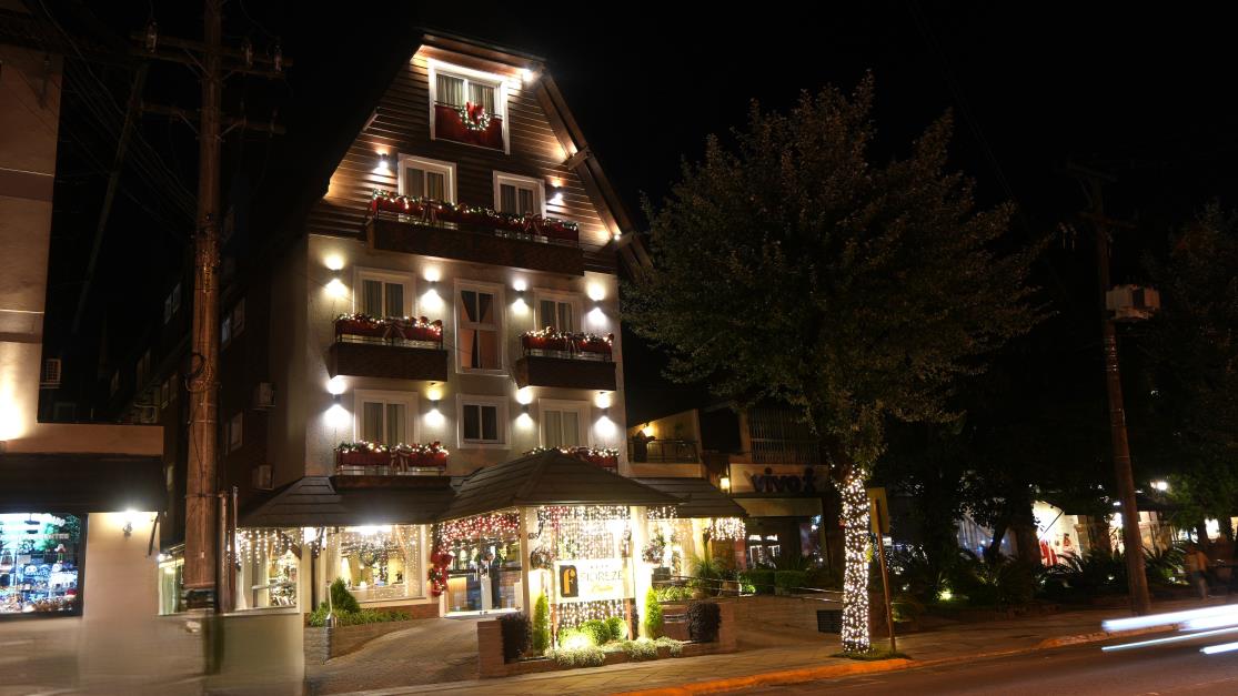 Fachada iluminada de hotel em Gramado ao anoitecer